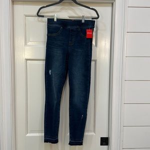 Spanx skinny jeans with distressed bottom. Size SMALL
